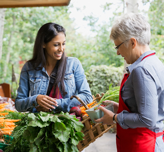 Woman shopper talking with vendor at a farmers' market